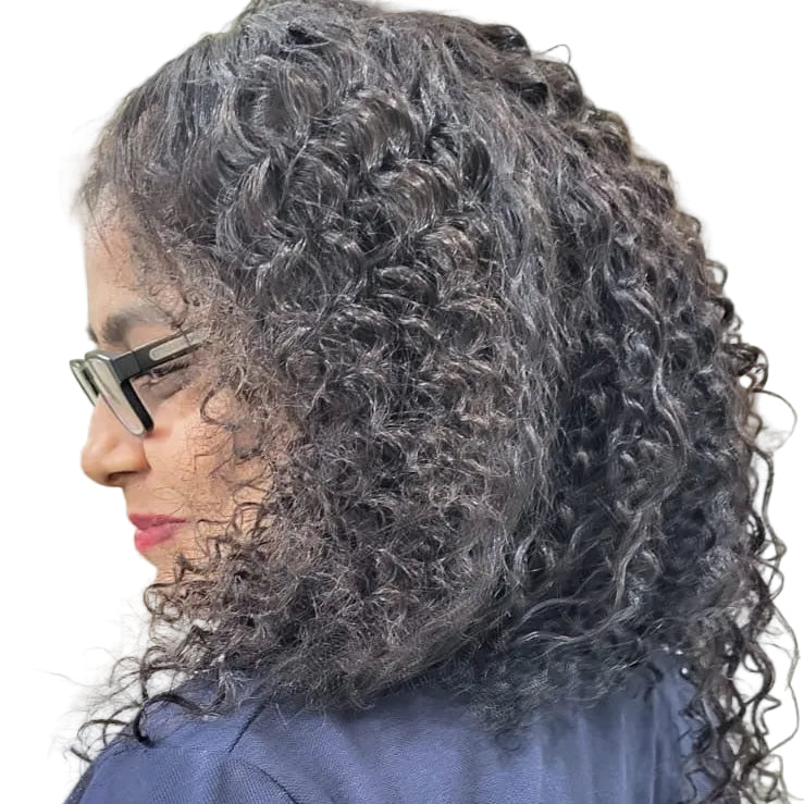 Person with curly hair wearing a blue shirt indoors