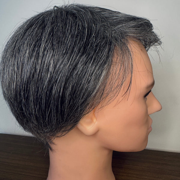 Mannequin head with a gray wig on a wooden surface