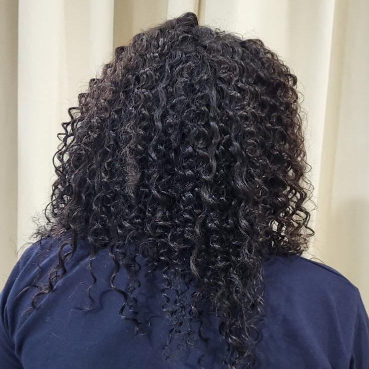 Person wearing a navy blue shirt with a neutral background