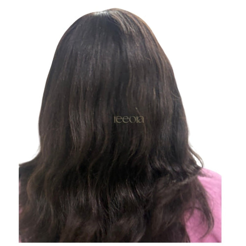 A ready-to-wear wig in dark brown, worn and seen from behind